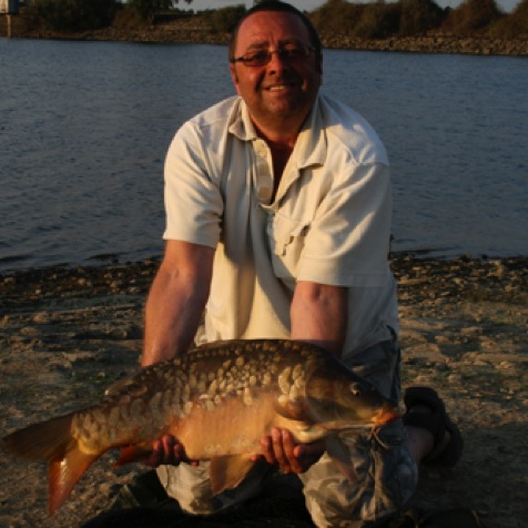 Terry - a regular visitor from England with a medium size carp